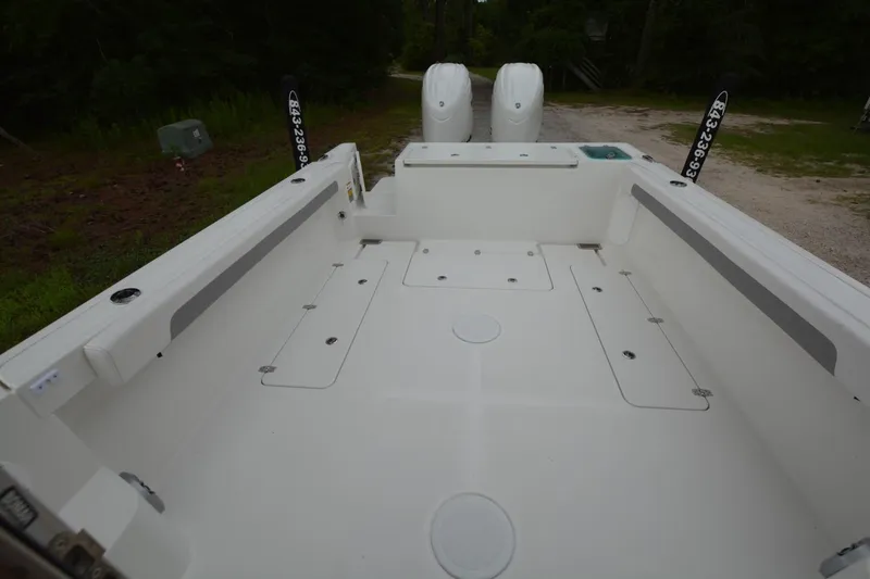 Slide: The Image of 2025 Parker 2420 boat interior with spacious deck and dual engines. - 20