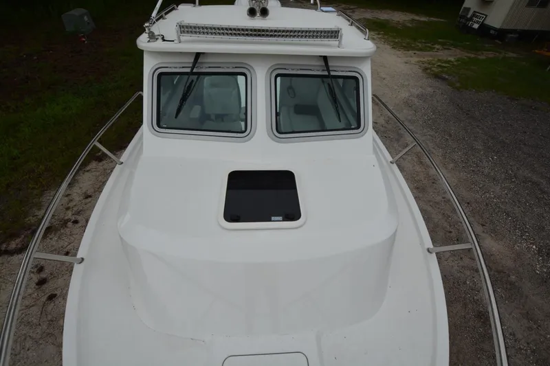 Slide: The Image of 2025 Parker 2420 boat, top view showing cabin windows and deck details. - 4