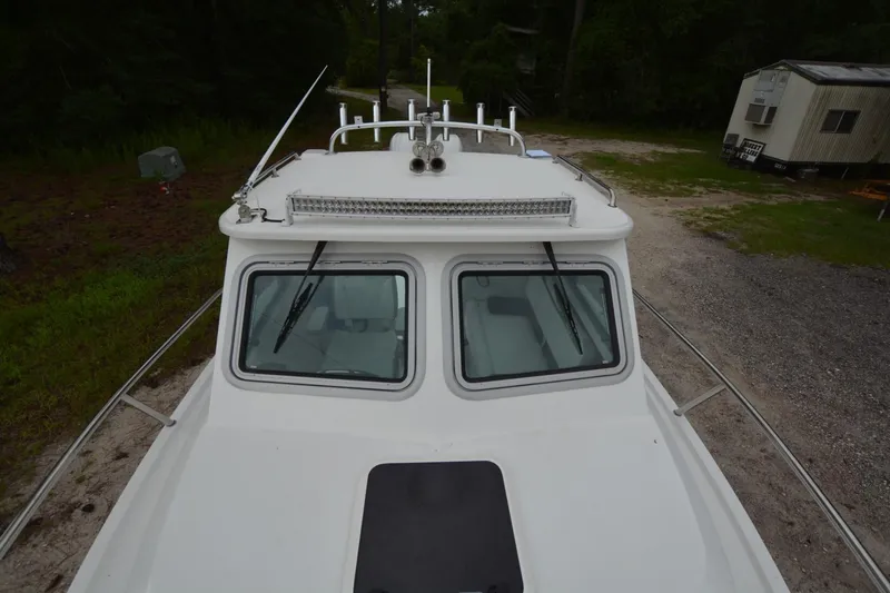 Slide: The Image of Parker 2420 boat, 2025 model, top view showing cabin and deck details. - 5