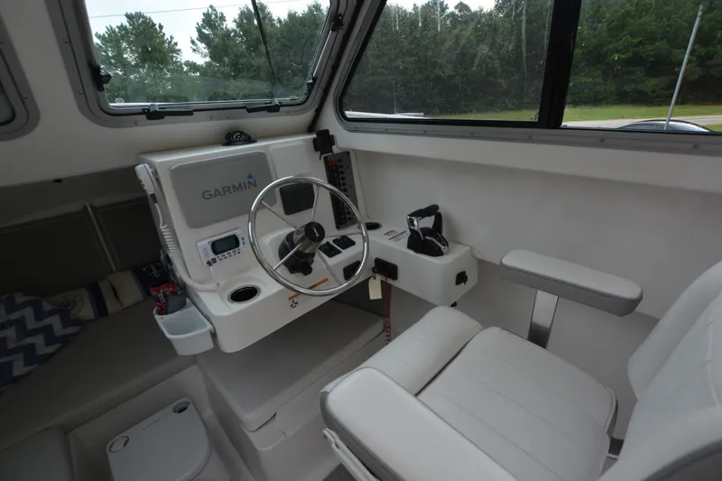 Slide: The Image of Interior of Parker 2420 boat, featuring Garmin navigation system and comfortable seating, 2025 model. - 7