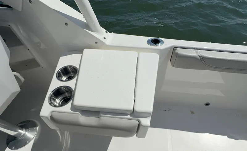 Slide: The Image of 2023 Pursuit DC 246 Dual Console boat interior with cup holders and seating. - 15