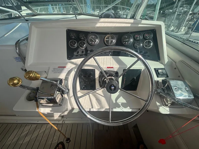 Slide: The Image of 1998 Wellcraft 330 Coastal boat helm with steering wheel and control panel. - 10