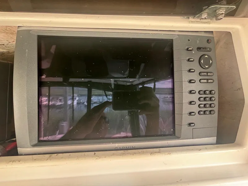 Slide: The Image of Garmin marine GPS system on a 1998 Wellcraft 330 Coastal boat dashboard. - 11
