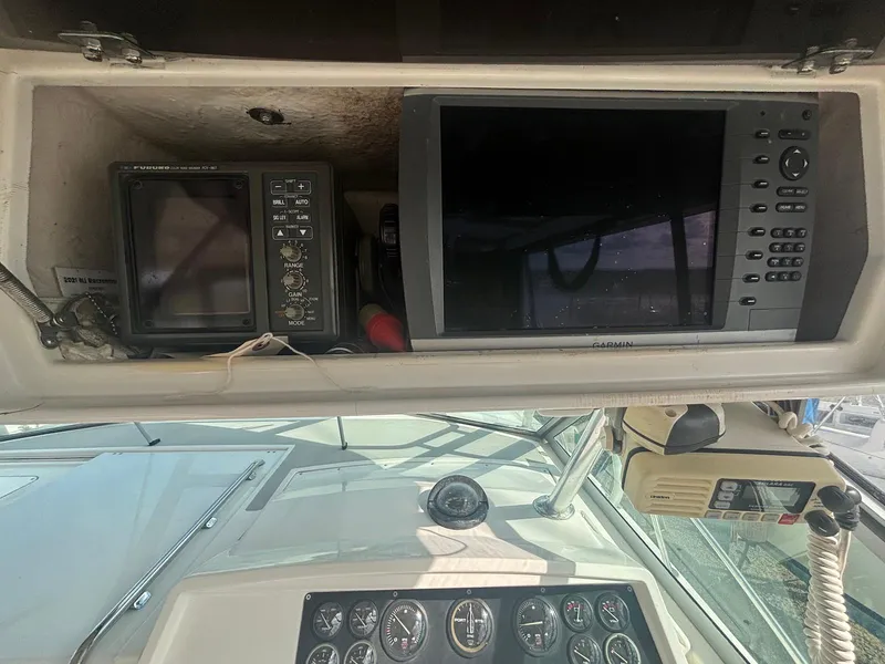 Slide: The Image of 1998 Wellcraft 330 Coastal boat dashboard with navigation equipment and gauges. - 12