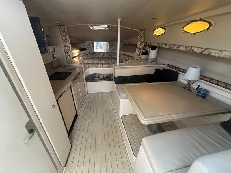 Slide: The Image of 1998 Wellcraft 330 Coastal cabin interior with kitchenette, dining area, and sleeping quarters. - 15