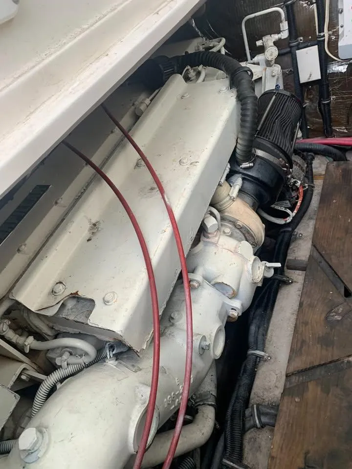 Slide: The Image of Engine compartment of a 1998 Wellcraft 330 Coastal boat, showing mechanical components and wiring. - 25