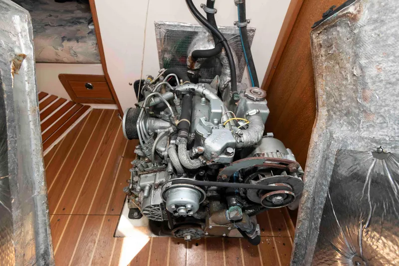 Slide: The Image of Engine of a 2003 Catalina 310 sailboat, displayed in a wooden interior compartment. - 17