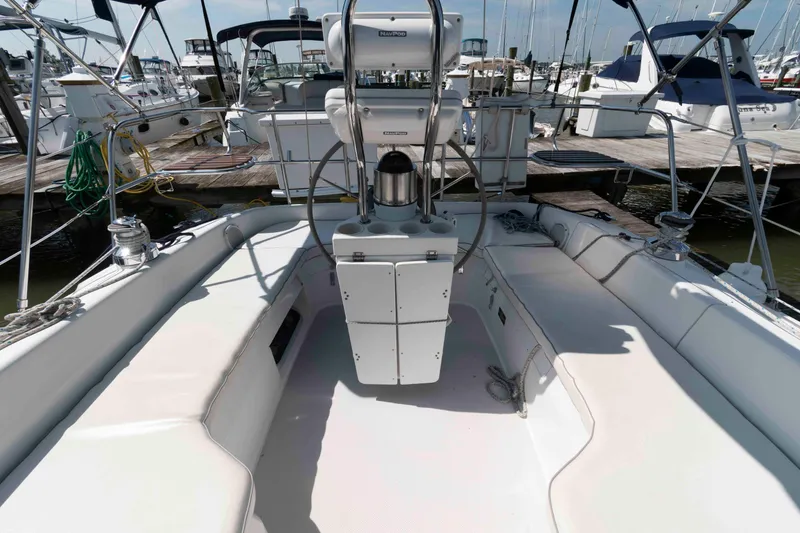 Slide: The Image of 2003 Catalina 310 sailboat cockpit with seating and steering wheel at marina. - 3