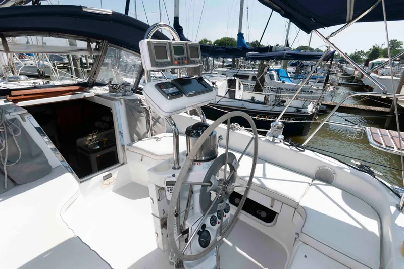 Slide: The Image of Cockpit of a 2003 Catalina 310 sailboat with steering wheel and navigation instruments. - 4