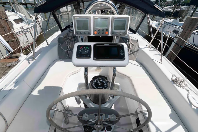 Slide: The Image of Cockpit of 2003 Catalina 310 sailboat with navigation instruments and steering wheel. - 5