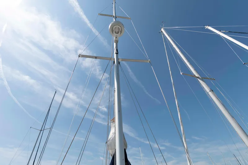Slide: The Image of Masts of a 2003 Catalina 310 sailboat against a clear blue sky. - 9
