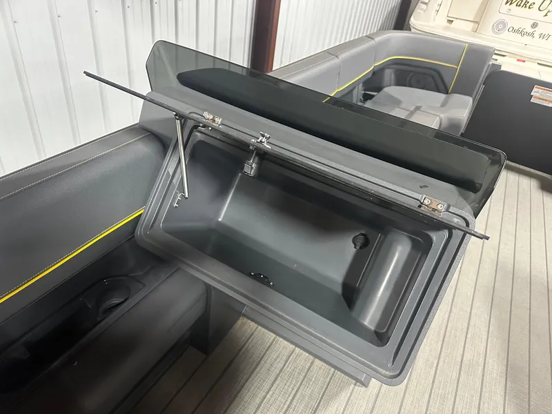 Slide: The Image of 2023 Manitou Explore 24 Navigator with Trifold Bench, featuring open storage compartment. - 11