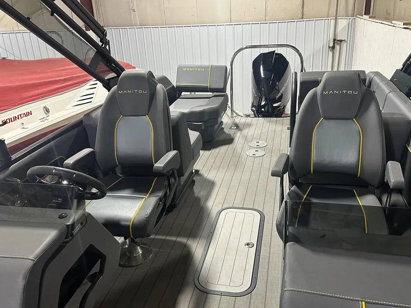 Slide: The Image of 2023 Manitou Explore 24 Navigator interior with trifold bench, featuring sleek seating and modern design. - 15