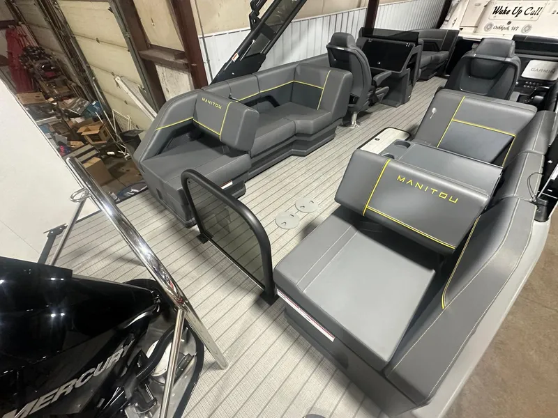 Slide: The Image of 2023 Manitou Explore 24 Navigator boat interior with trifold bench seating. - 17