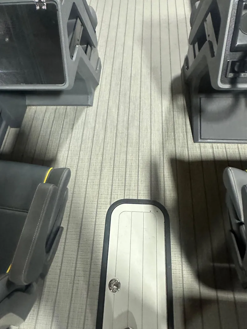 Slide: The Image of Interior of 2023 Manitou Explore 24 Navigator with Trifold Bench, featuring sleek seating and flooring. - 18