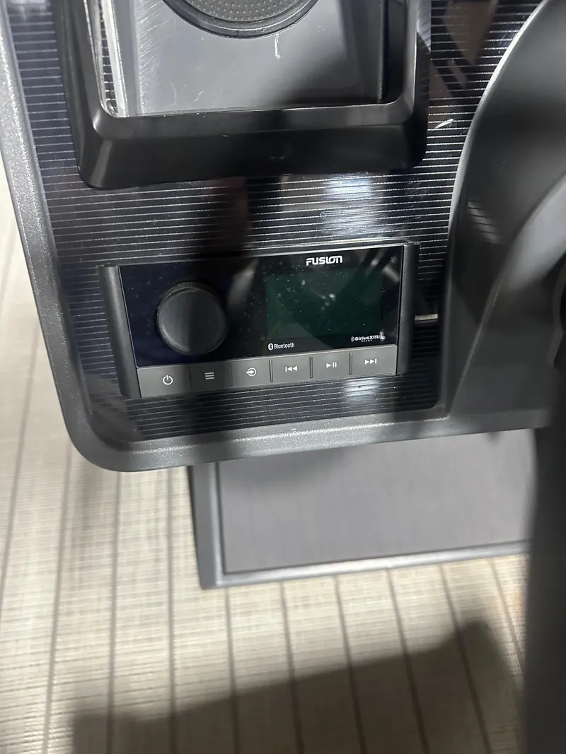 Slide: The Image of Control panel of 2023 Manitou Explore 24 Navigator with Fusion audio system. - 19