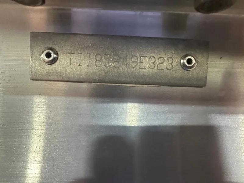 Slide: The Image of 2023 Manitou Explore 24 Navigator serial number plate on metal surface. - 23