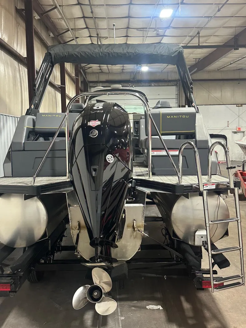 Slide: The Image of 2023 Manitou Explore 24 Navigator with Trifold Bench, rear view in warehouse setting. - 3