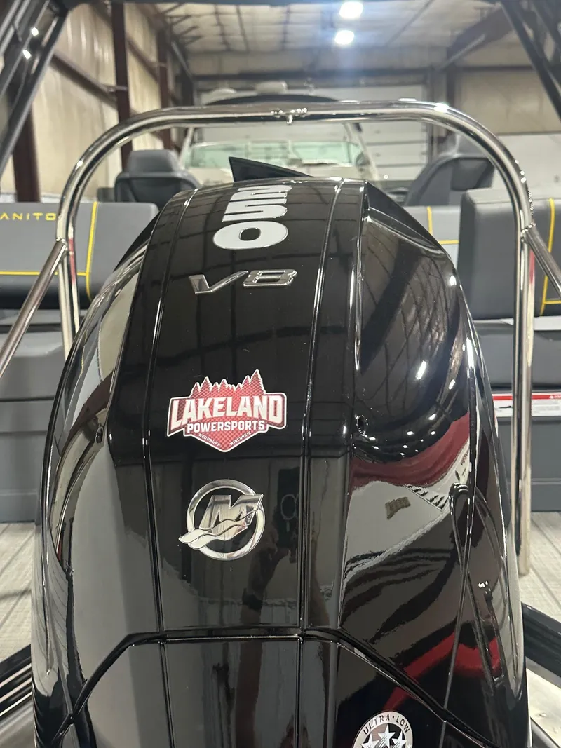 Slide: The Image of 2023 Manitou Explore 24 Navigator with V8 engine, Lakeland Powersports sticker. - 4