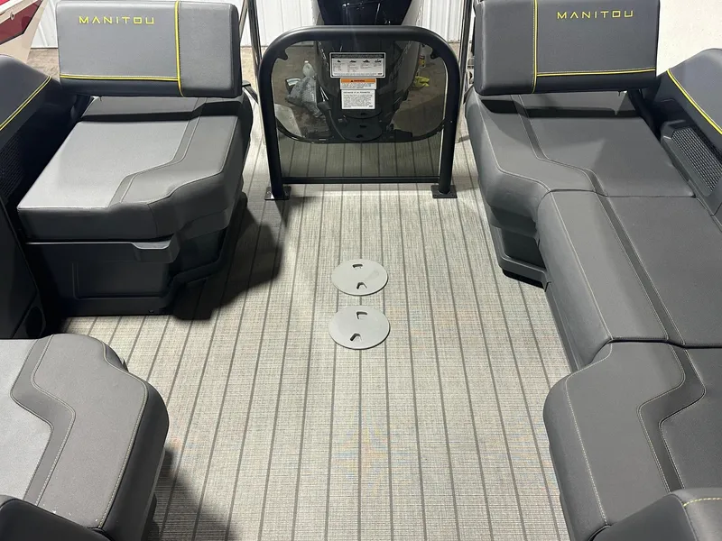 Slide: The Image of 2023 Manitou Explore 24 Navigator interior with trifold bench seating, gray upholstery, and modern design. - 6