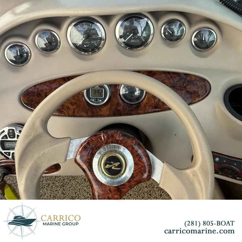 Slide: The Image of Dashboard of a 2003 Sea Ray 220 Bow Rider boat with gauges and steering wheel. - 10