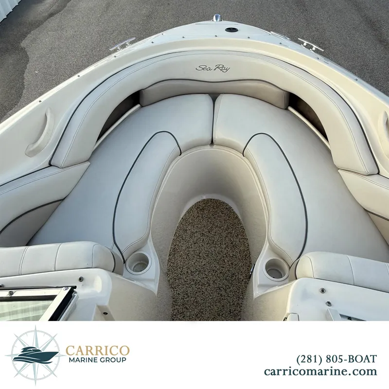 Slide: The Image of 2003 Sea Ray 220 Bow Rider interior with white seating, showcased by Carrico Marine Group. - 11