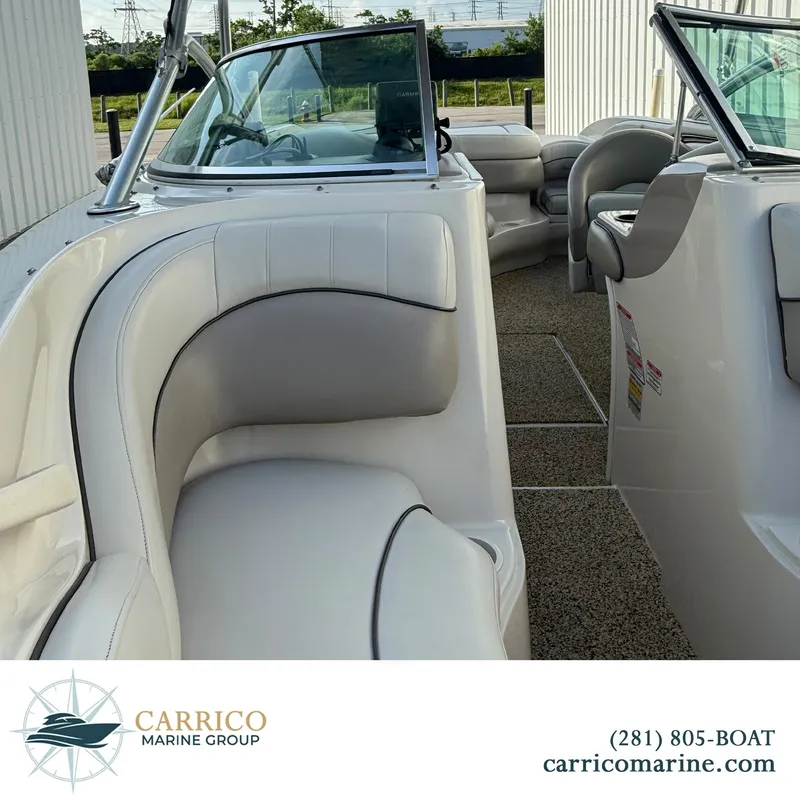 Slide: The Image of 2003 Sea Ray 220 Bow Rider interior with white seating, showcased by Carrico Marine Group. - 12