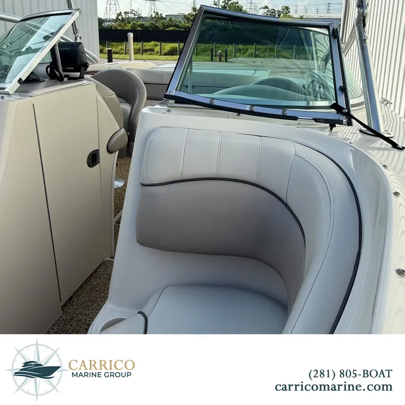 Slide: The Image of 2003 Sea Ray 220 Bow Rider interior with white seating, showcased by Carrico Marine Group. - 13