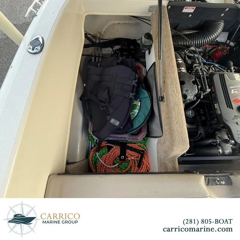 Slide: The Image of 2003 Sea Ray 220 Bow Rider engine compartment with storage and equipment. - 15