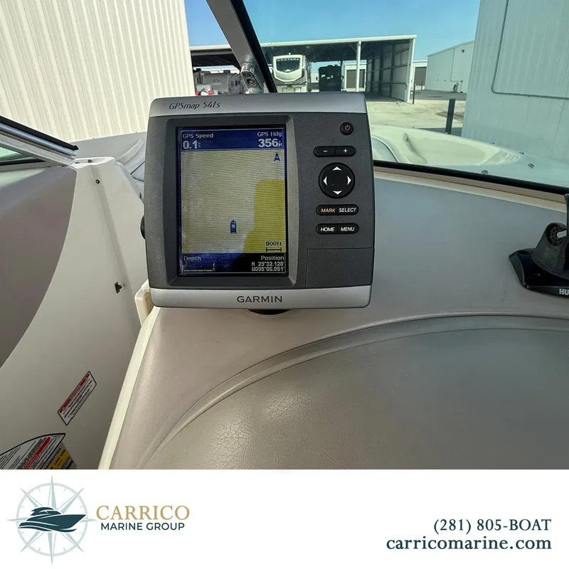 Slide: The Image of Garmin GPS on 2003 Sea Ray 220 Bow Rider dashboard, Carrico Marine Group branding. - 16