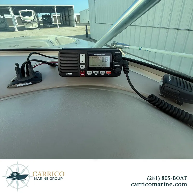 Slide: The Image of Dashboard of a 2003 Sea Ray 220 Bow Rider with marine radio and Humminbird device. - 17