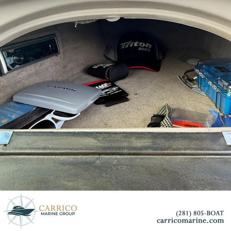 Slide: The Image of Storage compartment of a 2003 Sea Ray 220 Bow Rider with boating accessories. - 20