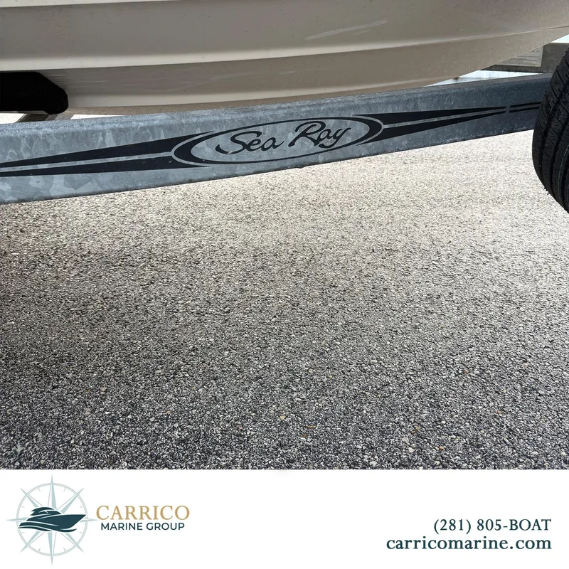 Slide: The Image of 2003 Sea Ray 220 Bow Rider boat trailer on asphalt, Carrico Marine Group branding. - 22