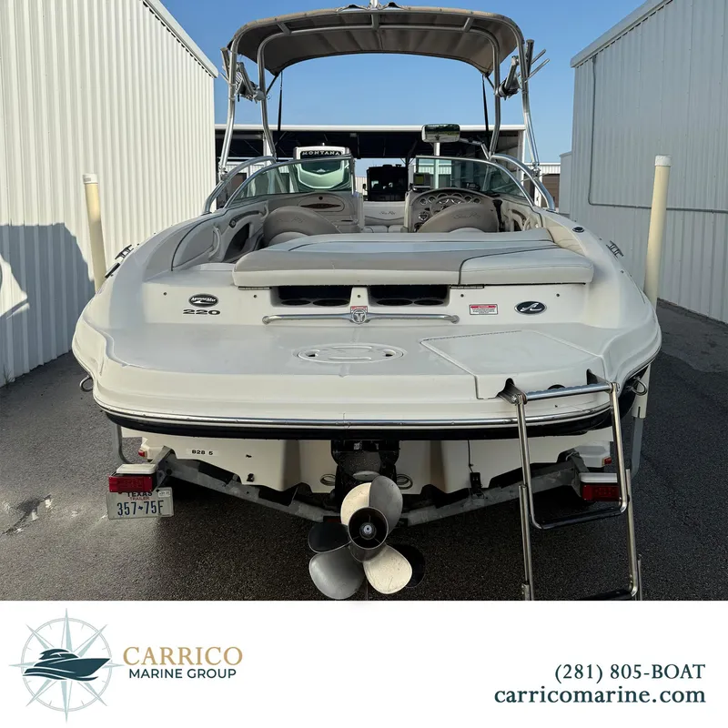 Slide: The Image of 2003 Sea Ray 220 Bow Rider boat, rear view, parked at Carrico Marine Group. - 4