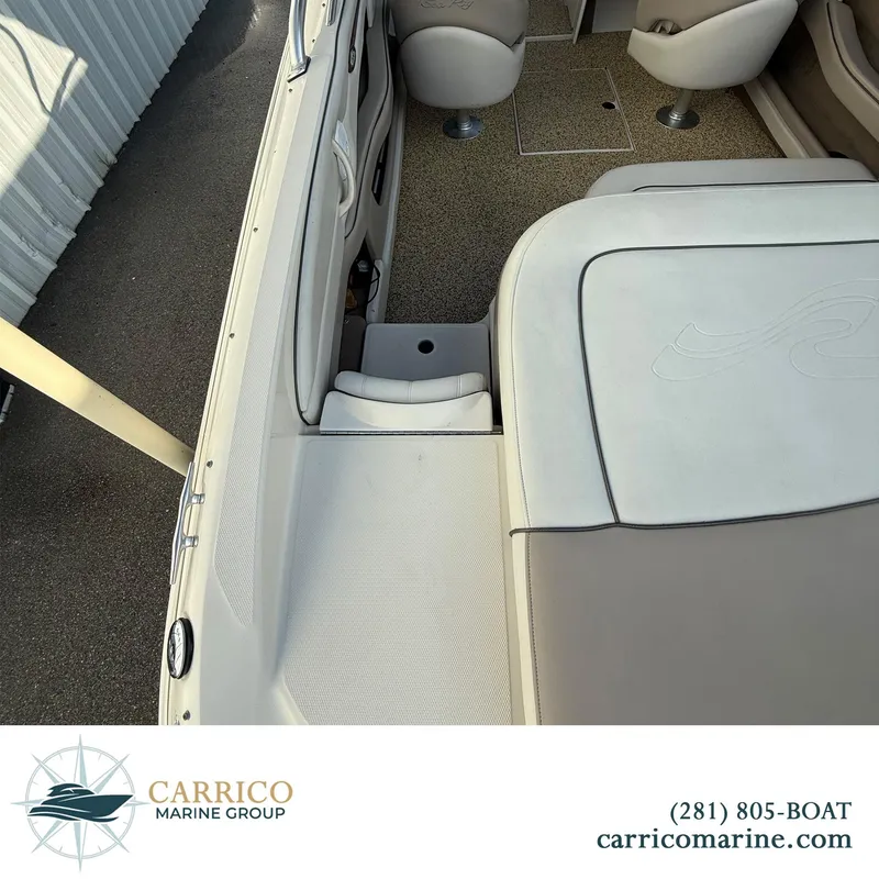 Slide: The Image of 2003 Sea Ray 220 Bow Rider interior with seating and carpeted floor, Carrico Marine Group. - 7
