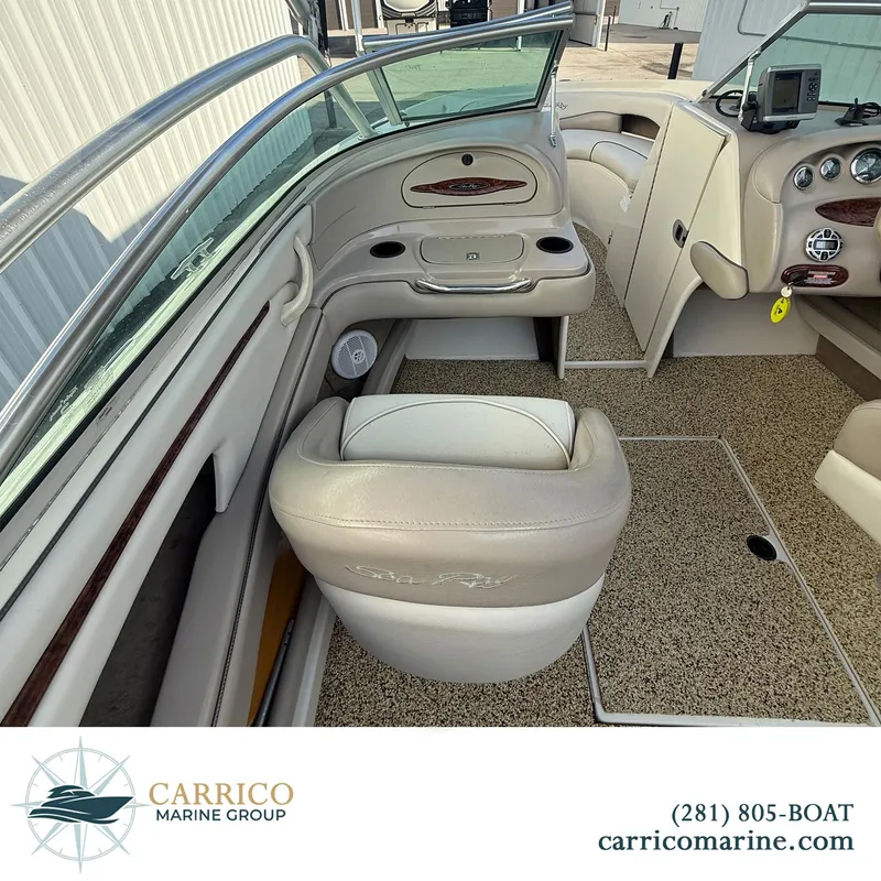 Slide: The Image of Interior of 2003 Sea Ray 220 Bow Rider boat with beige seating and dashboard. - 8