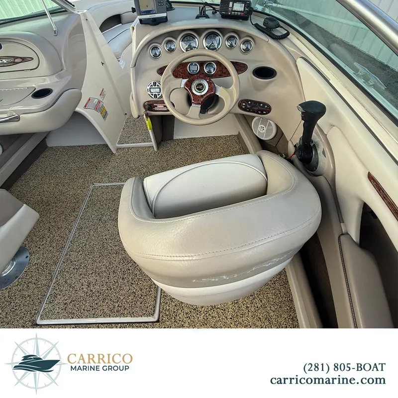 Slide: The Image of Interior of a 2003 Sea Ray 220 Bow Rider boat with steering wheel and controls. - 9