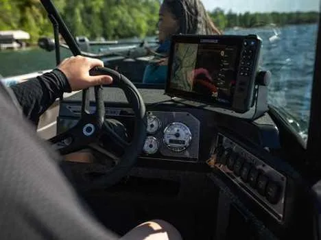 Slide: The Image of 2026 Lund 2075 IMPACT XS boat dashboard with navigation system on a sunny day. - 16