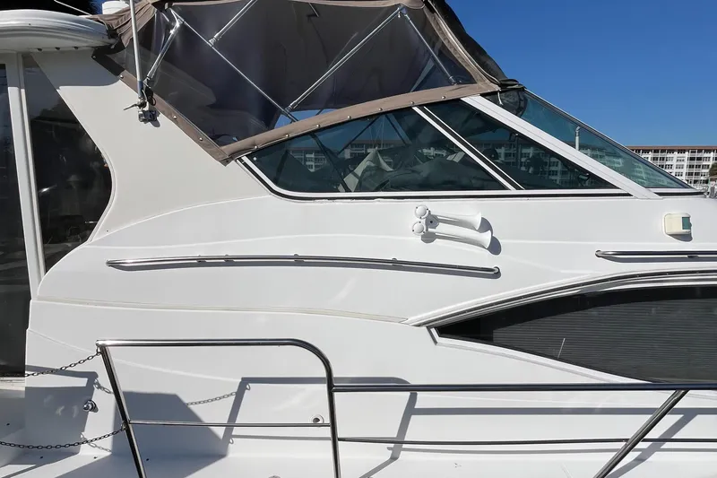 Slide: The Image of 2000 Cruisers Yachts 4450 Motor Yacht side view with clear blue sky background. - 12