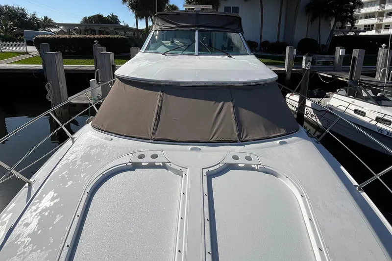 Slide: The Image of 2000 Cruisers Yachts 4450 Motor Yacht docked at marina, front view. - 20