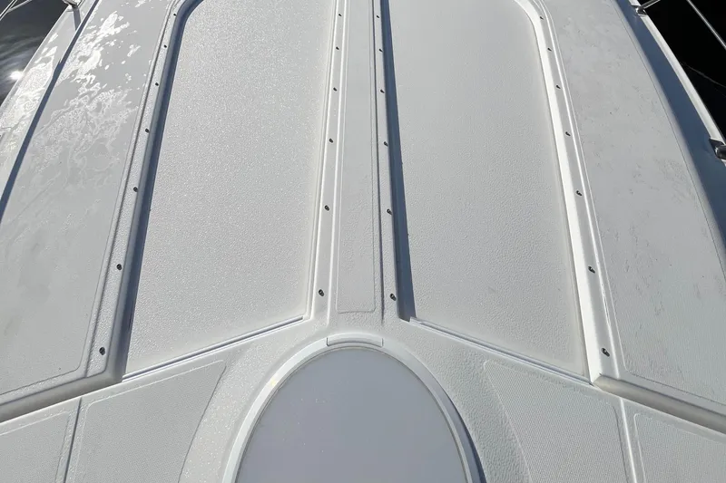 Slide: The Image of 2000 Cruisers Yachts 4450 Motor Yacht deck, featuring textured white surface. - 21