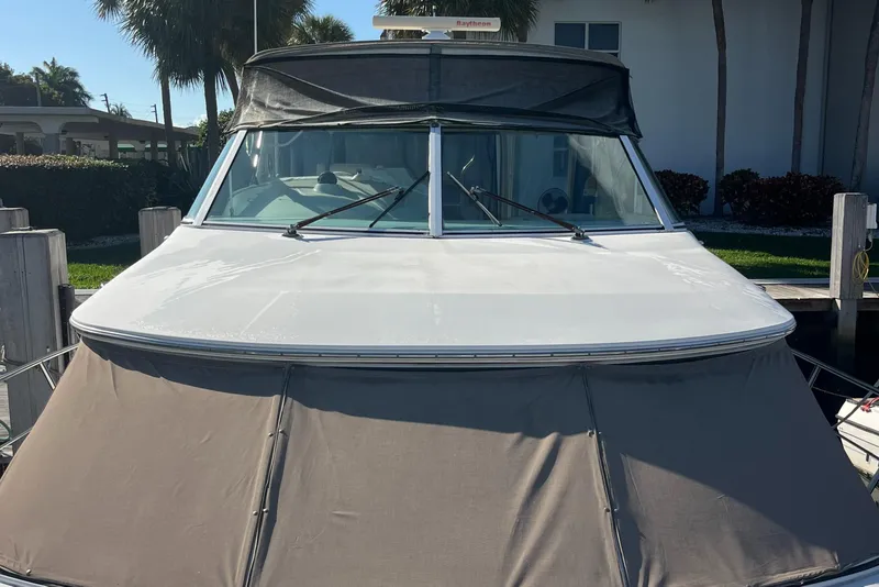 Slide: The Image of 2000 Cruisers Yachts 4450 Motor Yacht docked, front view with covered deck. - 22