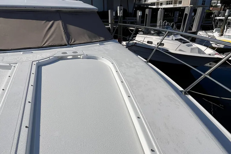 Slide: The Image of 2000 Cruisers Yachts 4450 Motor Yacht deck with railing, docked at marina. - 23