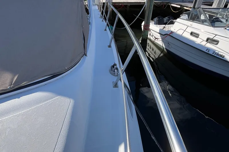 Slide: The Image of 2000 Cruisers Yachts 4450 Motor Yacht docked, showing deck and railing details. - 28