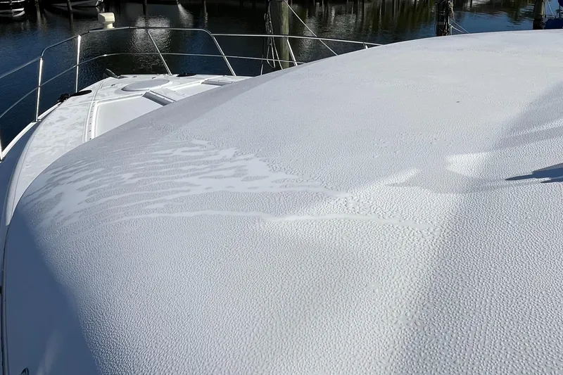 Slide: The Image of 2000 Cruisers Yachts 4450 Motor Yacht deck with water droplets, docked in marina. - 33