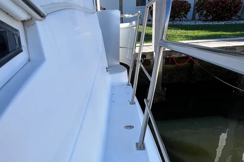 Slide: The Image of 2000 Cruisers Yachts 4450 Motor Yacht docked, showing side deck and railing. - 37