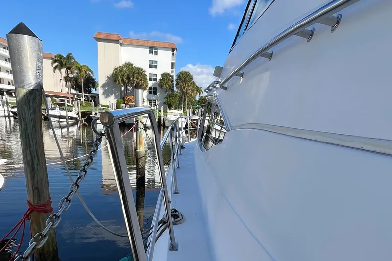 Slide: The Image of 2000 Cruisers Yachts 4450 Motor Yacht docked near waterfront buildings. - 46