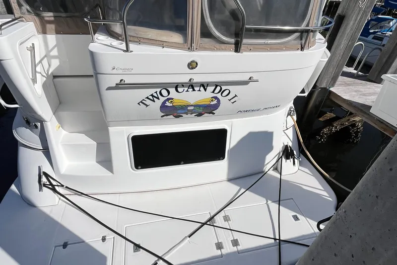 Slide: The Image of 2000 Cruisers Yachts 4450 Motor Yacht docked, featuring "Two Can Do It" name on stern. - 6