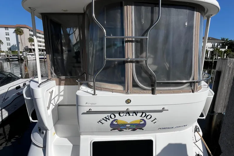 Slide: The Image of 2000 Cruisers Yachts 4450 Motor Yacht docked, featuring "Two Can Do II" name on the stern. - 7