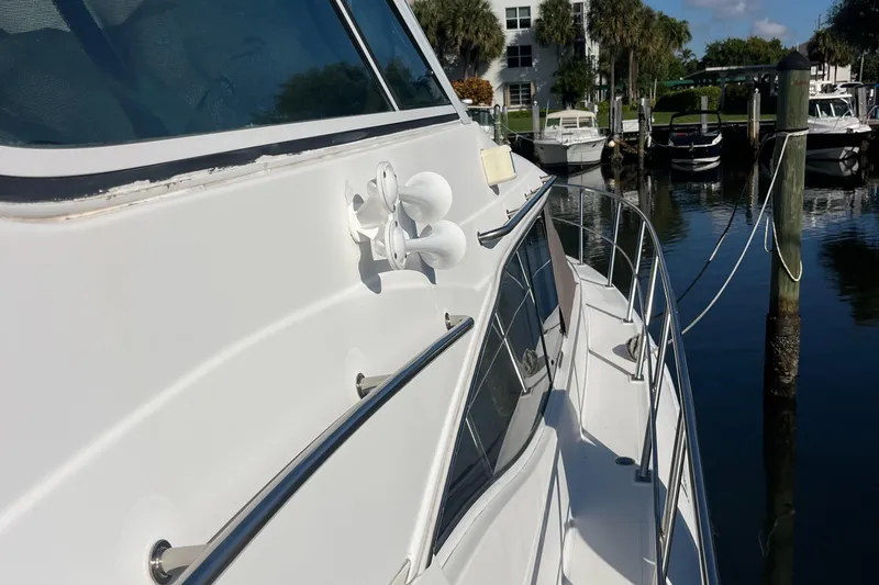 Slide: The Image of 2000 Cruisers Yachts 4450 Motor Yacht docked at marina, side view. - 15